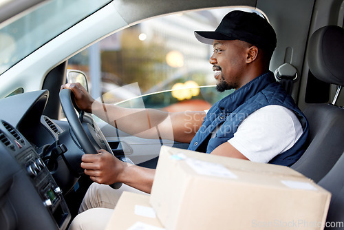Image of Delivery man, transport and man driving with a smile for shipping or courier service. Happy black person or driver with cardboard box, package or parcel in a van, cargo vehicle or transportation