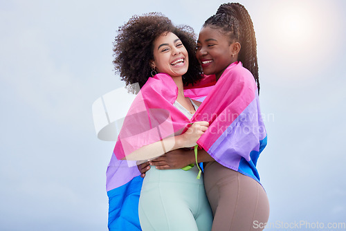 Image of Lesbian, couple and women with a flag, hug and support with romance, bonding and loving together. Romantic, happy girls or pride with equality, freedom or embrace with solidarity, lgbtq or liberation