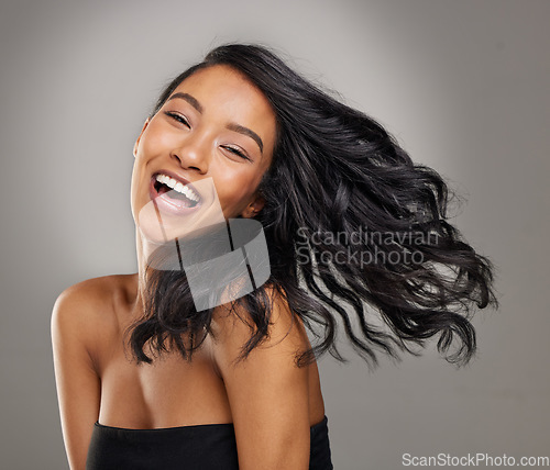 Image of Hair, smile and portrait of happy woman in studio for cosmetics, treatment and shine on grey background. Happy, face and haircare for female model with volume, texture and keratin result satisfaction