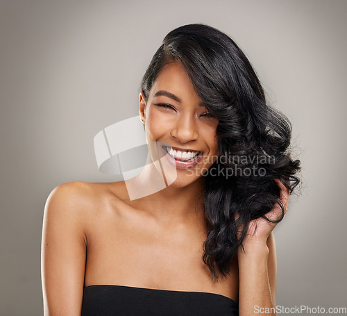 Image of Haircare, beauty and portrait of happy woman in studio for cosmetics, treatment and shine on grey background. Hair, face and satisfied female model posing with volume, texture and keratin results