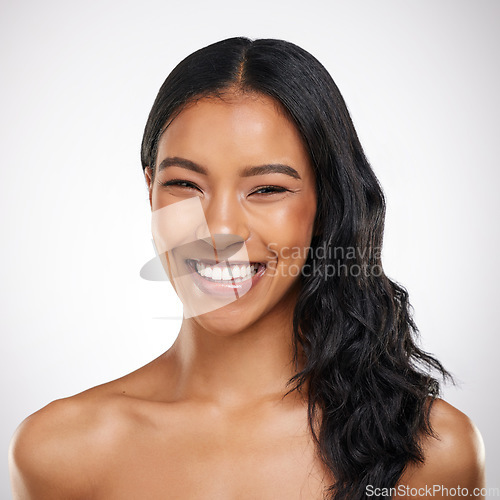 Image of Beauty, hair and portrait of happy woman in studio for cosmetics, treatment and shine on grey background. Smile, face and haircare for female model excited with volume, texture and keratin results