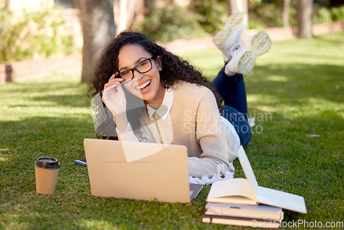 Image of Portrait of happy woman with laptop and notes in park for education, studying in nature and learning online. Smile, research and university student on campus grass with computer and books for project