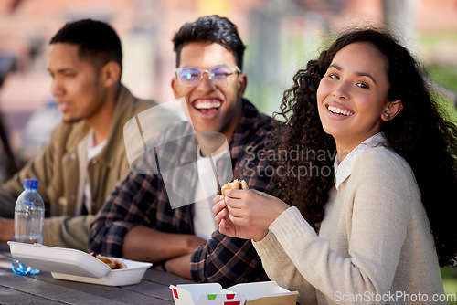 Image of Students, happy and friends eating lunch together on university or college campus for a break as a group. Smile, portrait and group of young people with food, burger or relax in a restaurant