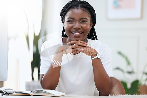 Image of Portrait of confident black woman at desk with smile, notebook and online research for small business administration. African businesswoman in office with pride planning schedule, proposal or report.