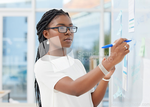 Image of Writing, office and black woman with focus at board planning a business analyst project. African female person, startup and professional with staff notes and moodboard working on company data