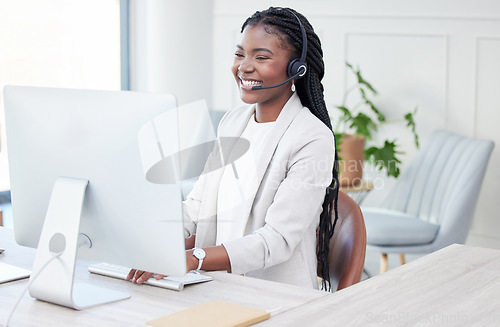 Image of Customer service, woman with headset and computer at her desk in her modern workplace. Telemarketing or call center, online communication or crm and black female person at her workstation for support