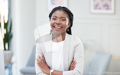 Image of Confidence, crossed arms and portrait of a businesswoman in the office with leadership and success. Happy, smile and professional African female corporate ceo standing with vision in her workplace.