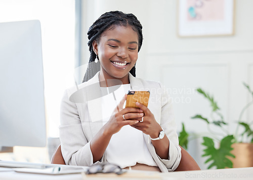 Image of Business, black woman and typing on phone at a desk for communication, chat and social media. Happy african female entrepreneur reading email or post on smartphone app with network connection