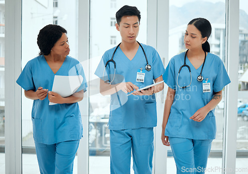 Image of Teamwork, discussion or nurses walking with tablet planning strategy in hospital in collaboration together. Leadership, doctors or surgeons talking or speaking of healthcare research or digital news