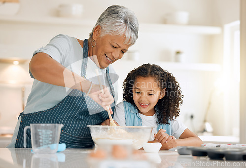 Image of Grandmother, cooking or child baking in kitchen as a happy family with young girl learning cookies recipe. Mixing cake flour, development or grandma smiling, helping or teaching kid to bake at home