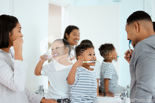 Image of Dental, family brush their teeth and in bathroom of their home together in the morning. Care or love with hygiene, wellness and black people cleaning for healthcare with toothbrush at their house