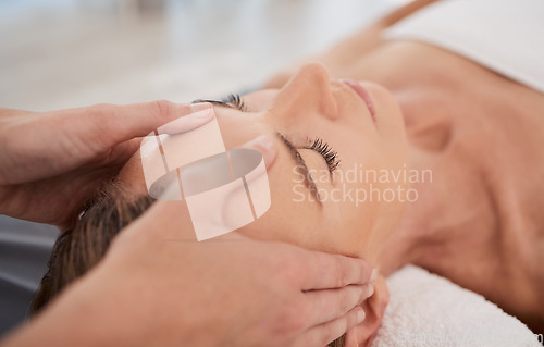 Image of Spa, relax and hands with a head massage for facial wellness, luxury therapy and sleep. Skincare, health and a masseuse massaging temple of a woman at a salon for reflexology and acupressure