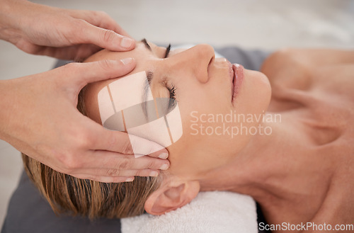 Image of Spa, treatment and hands with a head massage for facial wellness, luxury therapy and sleep. Skincare, health and a masseuse massaging temple of a woman at a salon for reflexology and acupressure