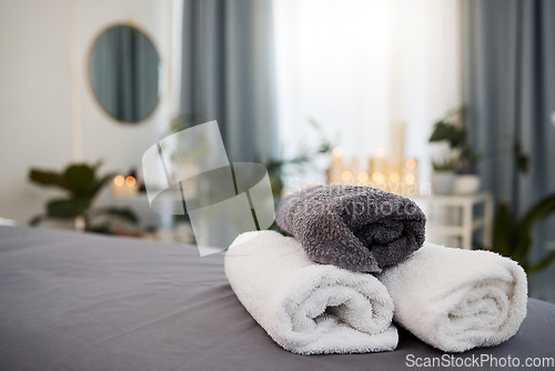 Image of Towel, bed and spa background for wellness, luxury and health industry with candle bokeh for calm or peace. Massage, hotel and room for holiday or vacation, interior design and hospitality services