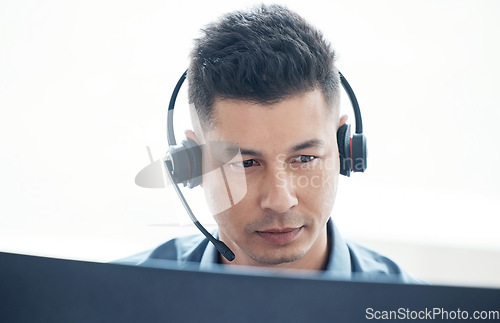 Image of Man, face with callcenter and phone call, CRM and headset for communication, technology and contact us. Customer service, telemarketing or tech support with male consultant and help desk worker