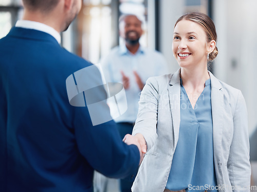 Image of Thank you, coworkers shaking hands and at office of their work together. Partnership or support, crm or agreement and cheerful colleagues with a handshake for greeting at their modern workplace