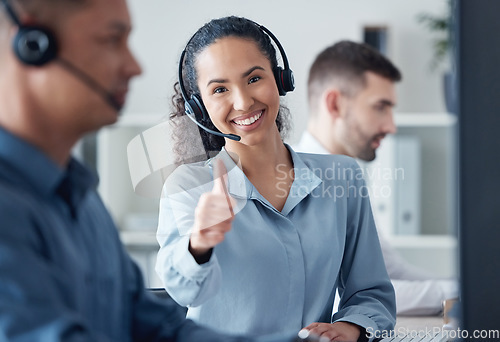 Image of Woman at callcenter, thumbs up in portrait and CRM, communication of support and agreement emoji. Contact us, customer service and tech, female agent with headset and smile, success and thank you