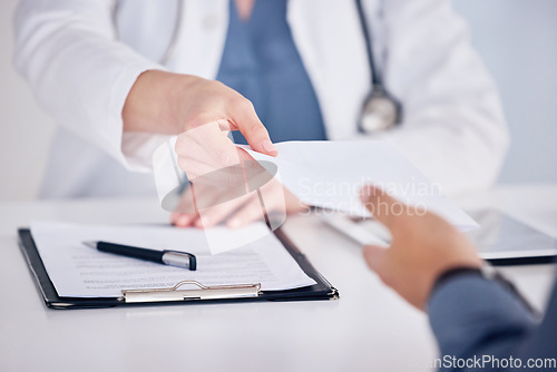 Image of Doctor, hands and customer with documents for prescription or healthcare consultation on office desk. Hand of medical professional giving doctors note to patient in consult or diagnosis at the clinic