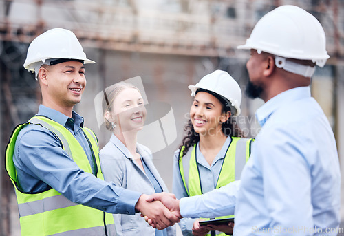 Image of Business people, architect and handshake in meeting for construction, partnership or teamwork on site. Happy employee workers shaking hands for team building, architecture or b2b agreement in city