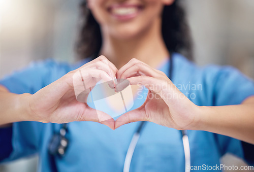 Image of Happy woman, doctor and heart shape hands for love in healthcare or life insurance at the hospital. Female person or medical professional showing hand loving emoji, symbol or sign gesture at clinic
