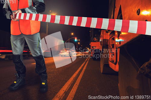 Image of Worker blocks repair street.