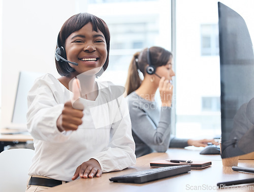 Image of Thumbs up, woman with headset and on a computer desk in her office at work. Telemarketing or customer service, online communication or consultant and crm with African female person at workspace