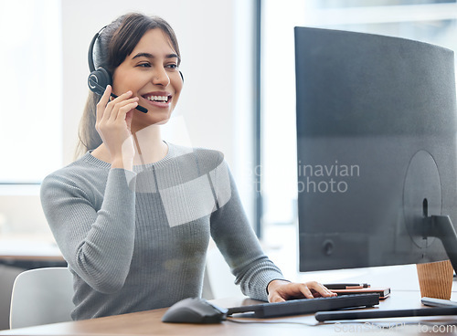 Image of Consultant, woman with headset and on a computer at her desk in a workplace office. Telemarketing or customer service, crm or client support and online communication with female person at workspace