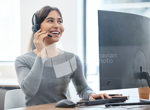 Image of Customer service, woman with headset and on a computer at her desk in a workplace office. Call center or consultant, crm or client support and telemarketing with female person at her workspace