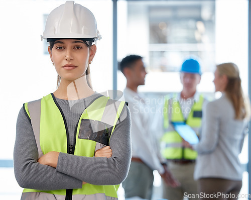Image of Architecture, woman portrait and arms crossed for planning, team leadership or project management. Engineering, construction and face of young person, contractor or manager in helmet and job mindset