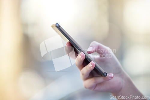 Image of Hand, phone and communication with a woman typing a text message closeup on a blurred background. Mobile, contact and social media with a female person reading a text or networking alone outdoor