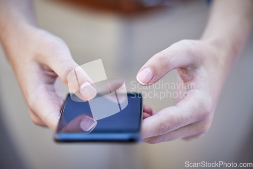 Image of Hands, phone and communication with a woman typing a text message closeup on a blurred background. Mobile, networking and social media with a female person reading a text or browsing alone outdoor