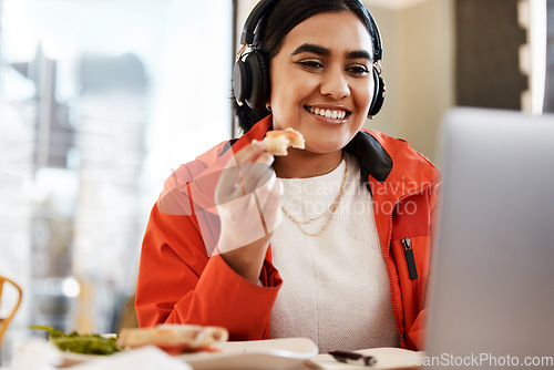 Image of Happy woman, student and eating by laptop while studying or streaming entertainment at home. Female person with smile on computer for food, study or elearning subscription in remote work at the house