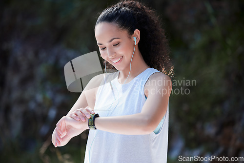 Image of Smart watch, fitness and woman in nature for exercise, training and workout while listening to music. Sports, motivation and happy female person check time for heart rate, wellness and performance