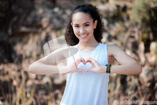 Image of Happy woman, portrait smile and heart hands for fitness, healthy wellness or exercise in nature. Fit, active and sporty female person smiling with loving shape hand for workout or health outdoors