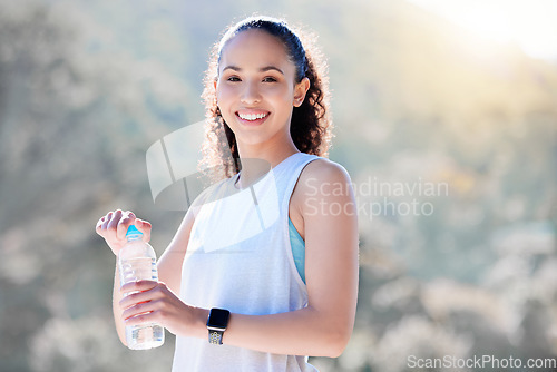 Image of Happy woman, portrait smile and water in fitness for sustainability, hydration or break from running in nature. Fit, active and sporty female person or runner smiling with bottle for thirst in run