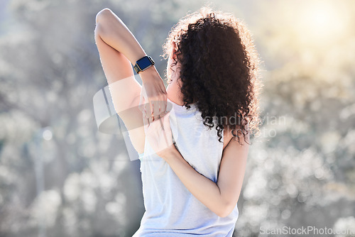 Image of Stretching, fitness and back of woman in nature for exercise, training and cardio workout with smart watch. Sports, healthy body and female person stretch arms for warm up, wellness and performance