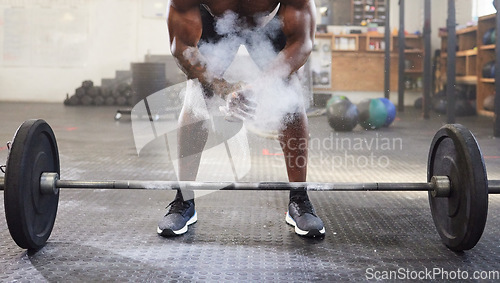 Image of Fitness, training and a man with powder for weightlifting, strength exercise and bodybuilding. Sports, challenge and a bodybuilder with gym chalk for a workout with weight and getting ready to lift