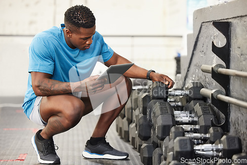 Image of Check list, man with a tablet and at the gym checking weights equipment. Fitness or workout, exercise or health wellness and African male worker with smartphone working for inventory training