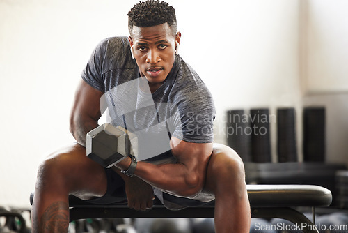 Image of Black man, bodybuilder and dumbbell in gym portrait for fitness, focus or training for growth, goal or competition. African guy, weightlifting and strong arms for training, wellness and muscle health