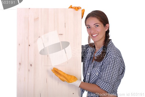 Image of woman carpenter holding wooden plank