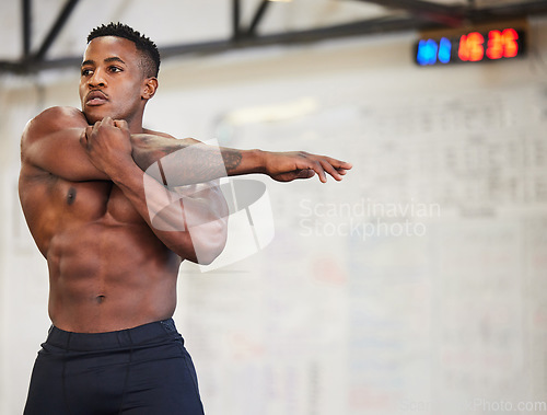 Image of Shirtless black man, stretching arms and fitness in gym with muscle, strong and abs with workout and mockup space. Focus, serious male athlete and bodybuilder, warm up and ready for exercise