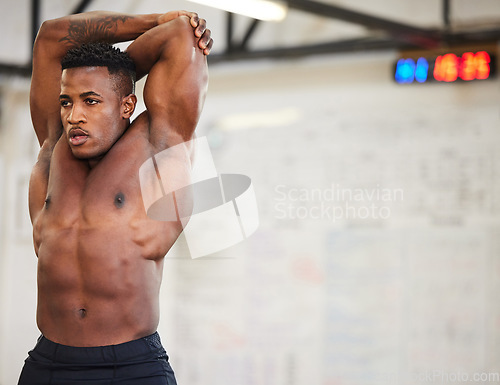 Image of Shirtless black man, stretching and fitness in gym with muscle, strong and abs with workout and mockup space. Serious male athlete, bodybuilder with warm up and ready for exercise with muscular arms