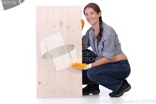 Image of woman carpenter holding wooden plank