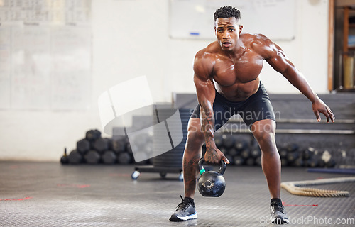 Image of Black man, fitness and weightlifting with kettlebell for workout, exercise or training at the gym. African male person or muscular bodybuilder lifting weight for strength sports or intense exercising