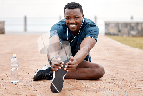 Image of Stretching legs, fitness and portrait of black man in park for exercise, marathon training and running. Sports, music and male person stretch for warm up, workout and listen to audio for wellness