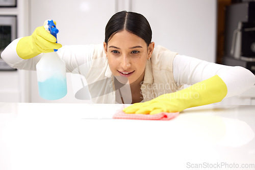 Image of Woman, clean table with chemical detergent spray and cloth with focus and wipe dirt. Housekeeping, female cleaner concentrate at home with hygiene, cleaning with bottle and disinfecting surface