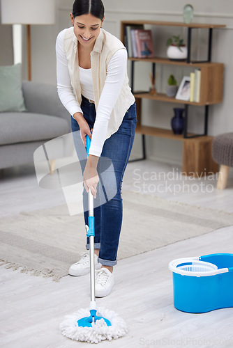 Image of Woman, mop living room floor and cleaning with hygiene and maintenance, housekeeping and smile while working. Disinfection, clean bacteria and female housekeeper with house work service and routine