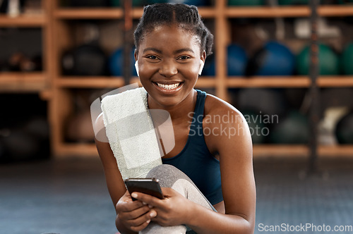 Image of Happy black woman, fitness and portrait with phone for social media, communication or networking at gym. Face of African female person typing, texting or chatting on smartphone after workout exercise