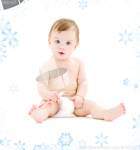 Image of baby boy in diaper with toothbrush