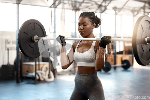 Image of Strong, workout and barbell with black woman in gym for fitness, weightlifting and muscle. Health, challenge and exercise with female bodybuilder and weights for focus, performance and commitment